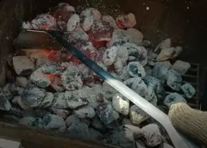 Weber Charcoal Grill Rake in action