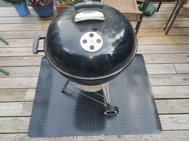 charcoal grill on a wooden deck